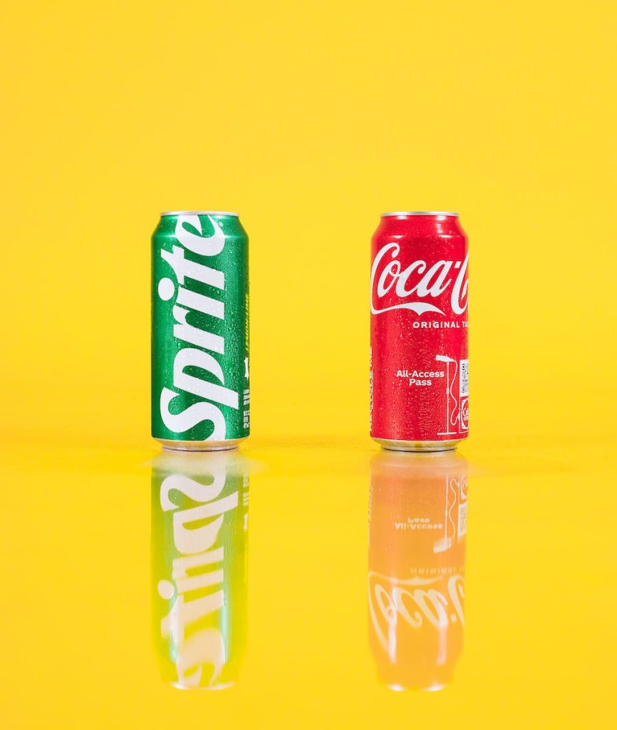 a couple of cans of soda sitting on top of a table